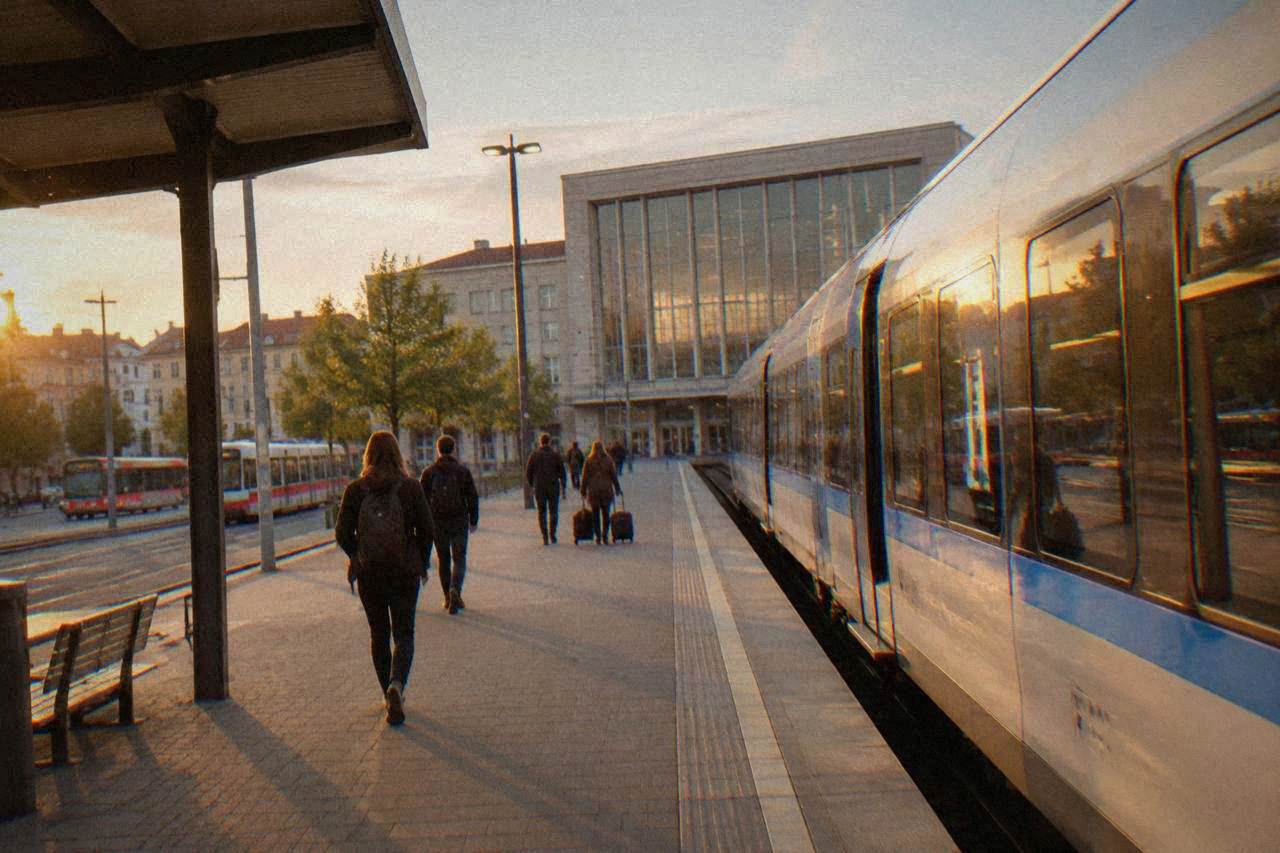A modern train standing at a platform in a Czech railway station