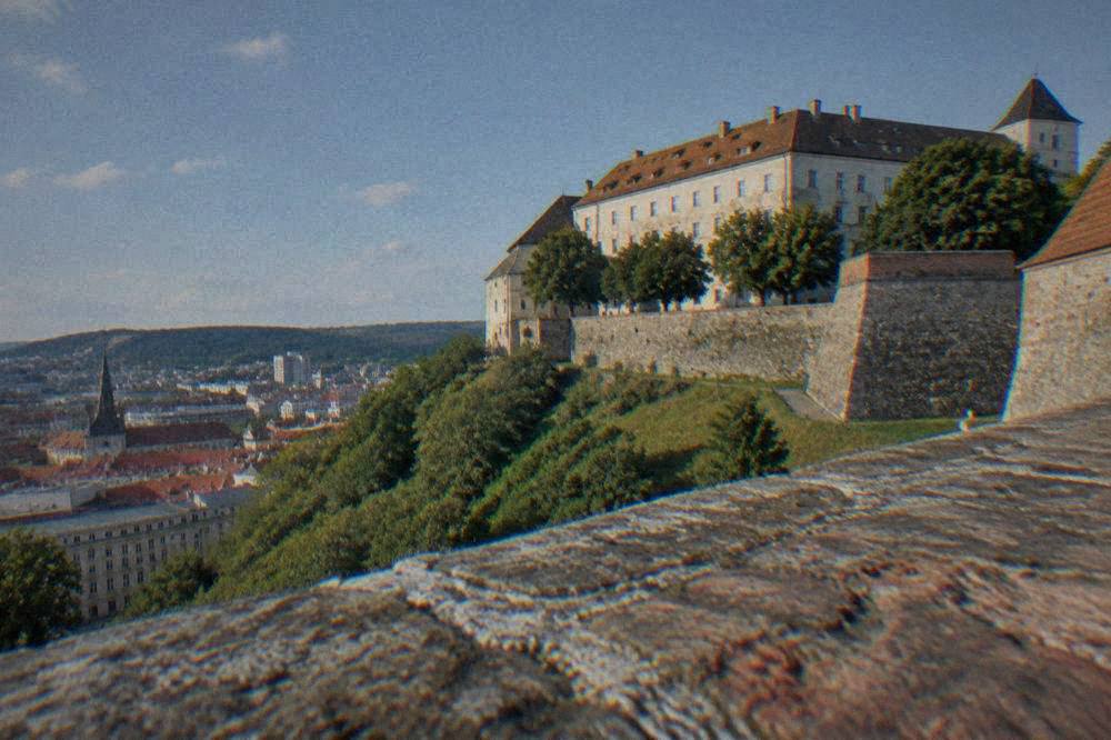 The thick walls and ramparts of Špilberk Castle above the city of Brno