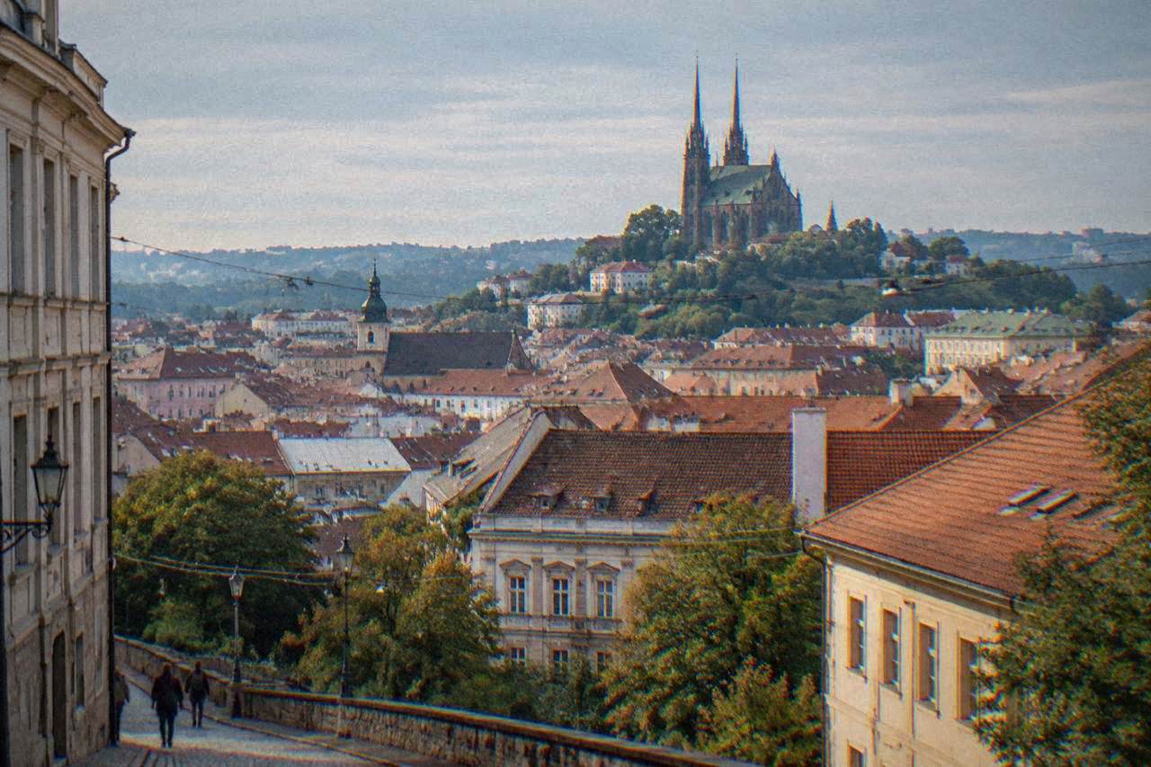 View over the red rooftops of Brno old town toward the twin spires of the Cathedral of Sts Peter and Paul