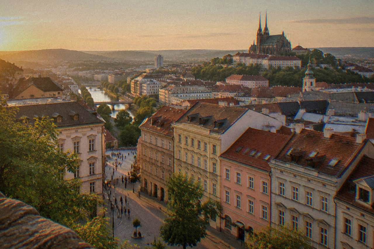 The rooftops and church towers of Brno seen from a hill above the city