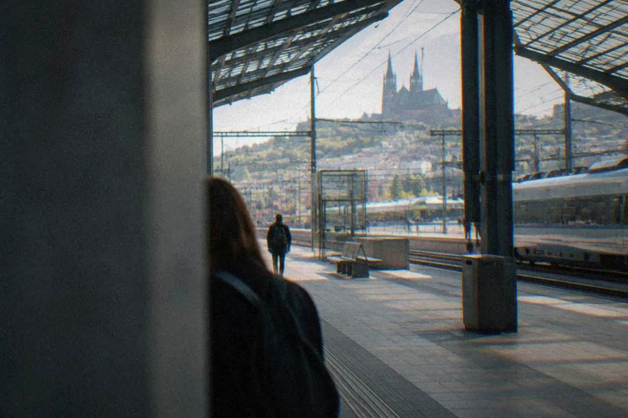 Train platforms under the glass roof of a city railway station in Brno