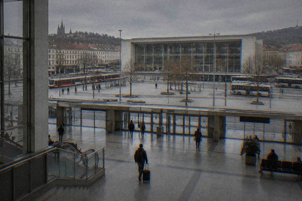 A traveller rolling a suitcase across the concourse of a main railway station