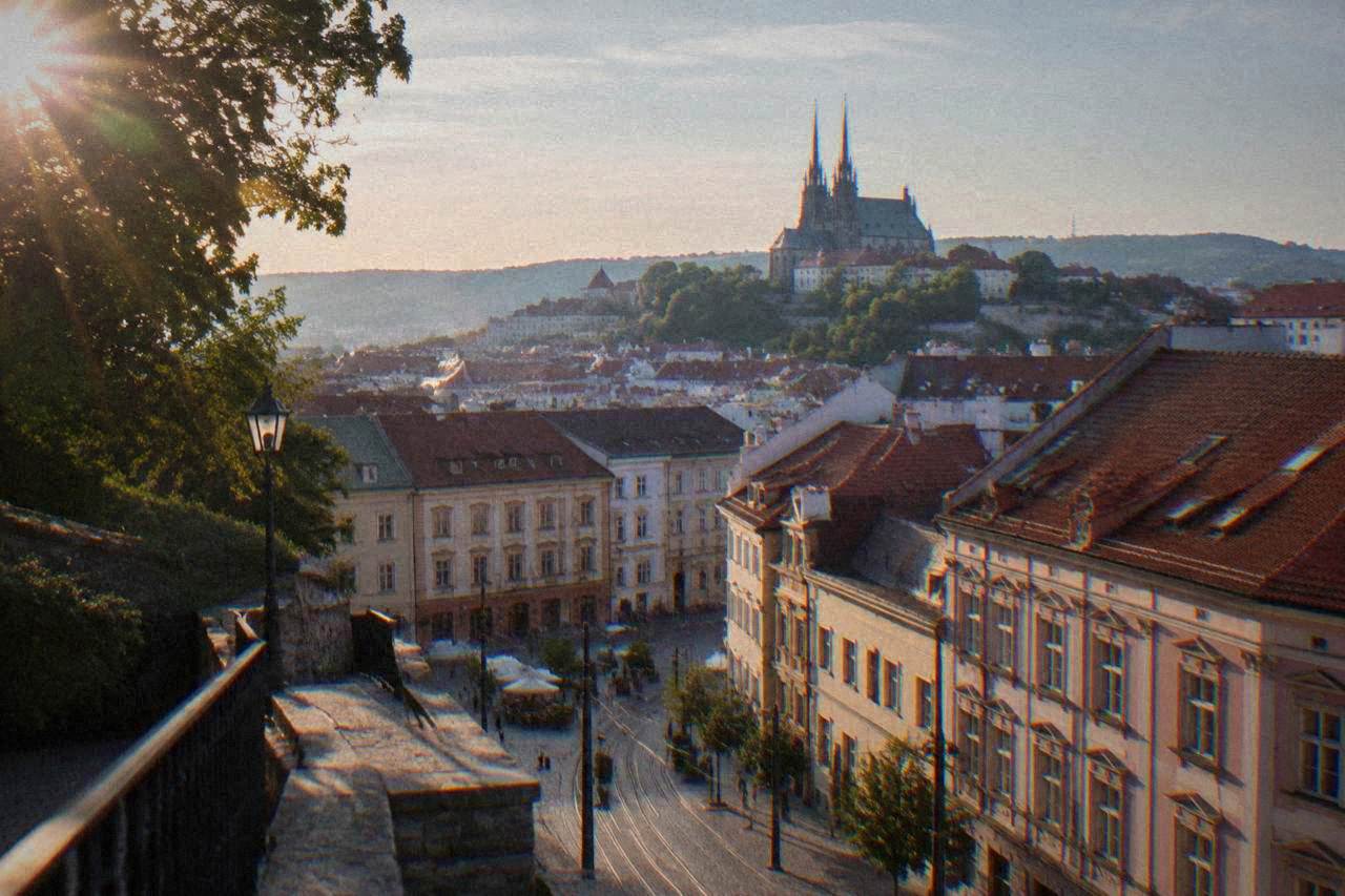 View over the red rooftops of Brno old town toward the twin spires of the cathedral on Petrov Hill
