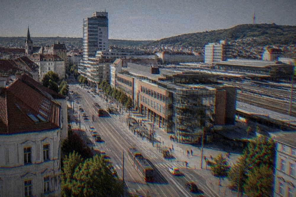 City avenue with trams near a railway station