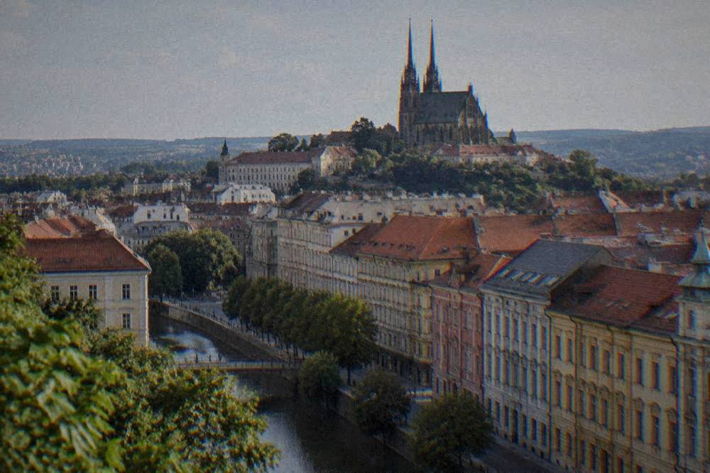 Panorama of Brno old town rooftops seen from a hill with the cathedral twin spires rising above red tiles