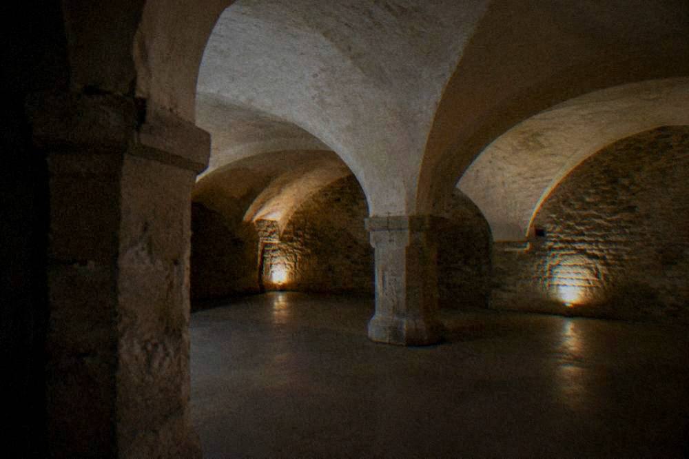 A Gothic church interior with stone pillars and tall windows