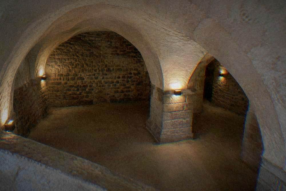 Vaulted underground chamber with stacked bones