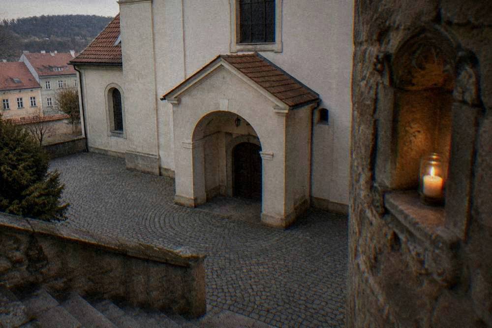 Candle niche in a stone crypt wall with worn carved details