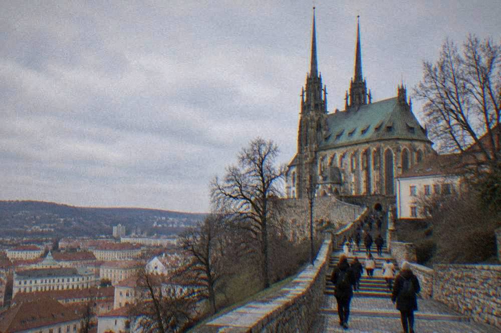 Visitors walking up the stepped path toward the cathedral entrance on Petrov Hill in Brno