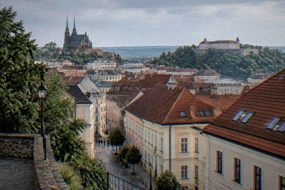 View across Brno rooftops from Petrov Hill toward Špilberk Castle on the opposite hill
