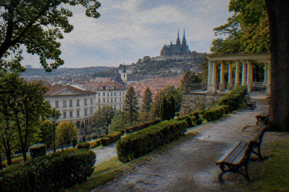 Narrow historic street rising toward a hilltop church in an old European city