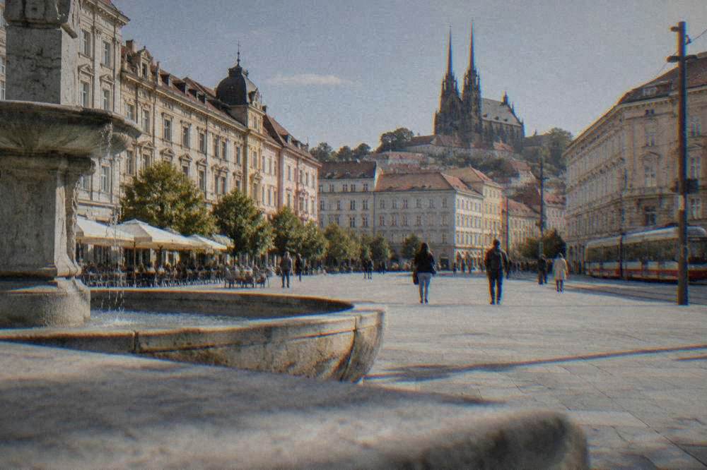 Twin spired cathedral on a hill above rooftops seen from central Brno