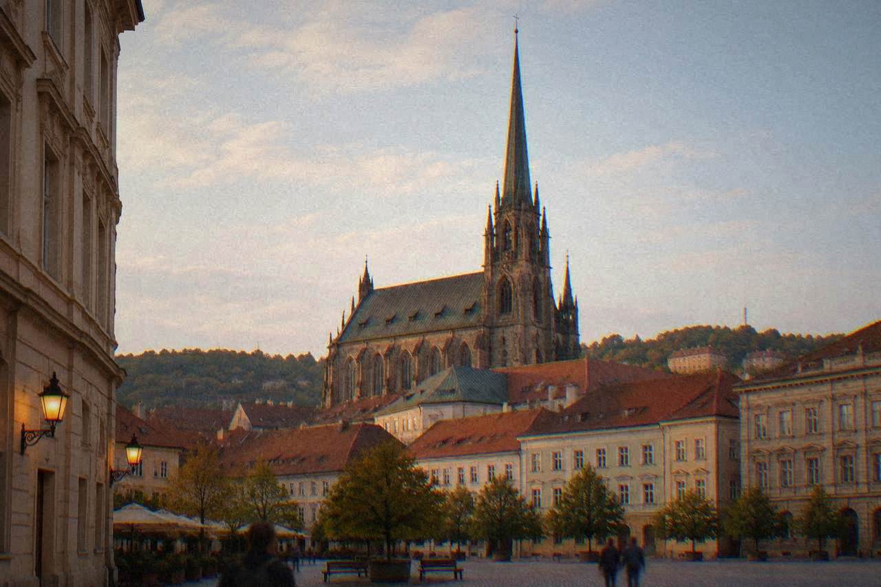 View over the Cabbage Market square in Brno with the portal of St James church rising behind the rooftops