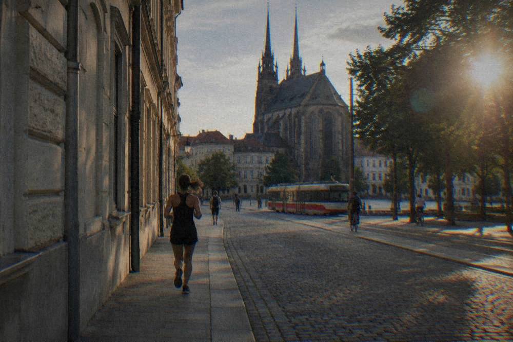 The stone facade of a Gothic church in Old Brno seen from a quiet street