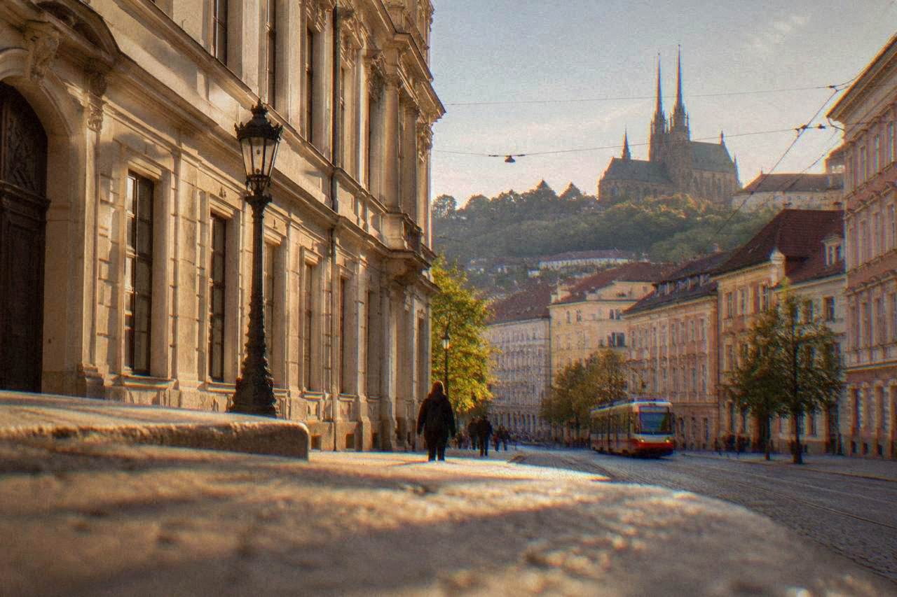 Classical palace facade with tall windows on a Brno street