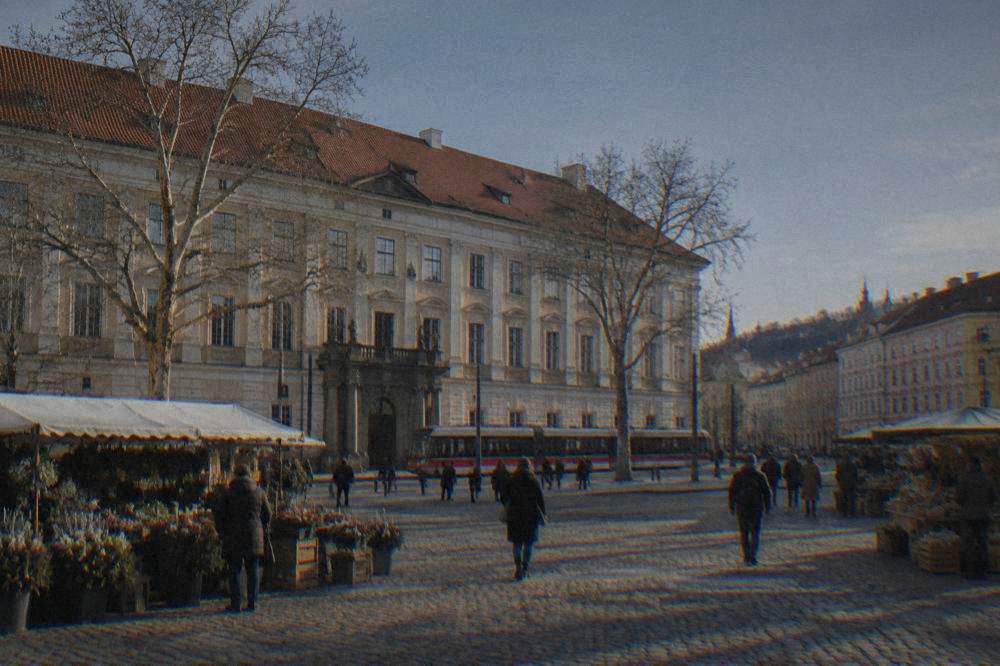 Cobbled square with market stalls and coloured baroque buildings