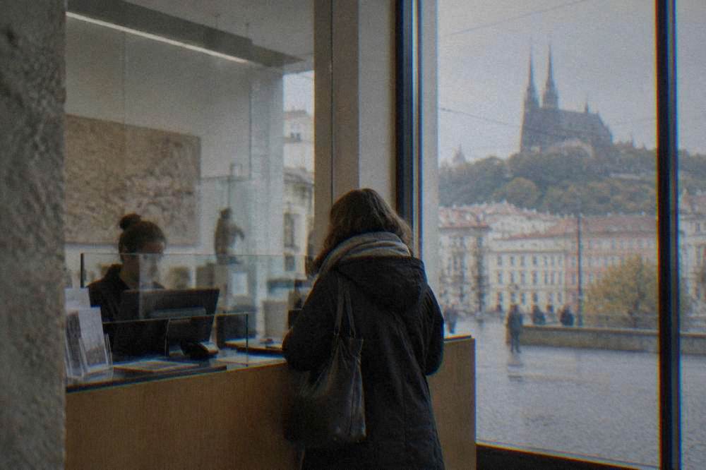 A ticket counter in a Brno museum with a visitor buying entrance tickets