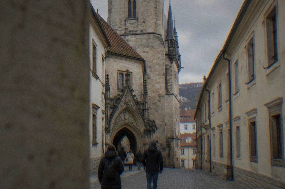 People walking through the arched passage of the Old Town Hall in Brno