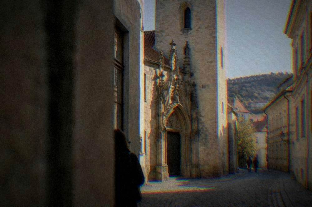 Old Town Hall portal and tower on a narrow lane, morning light