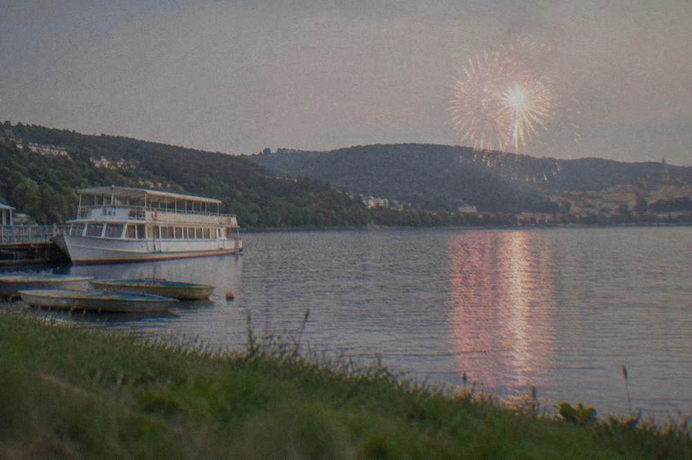 Fireworks reflecting on the water of the Brno Reservoir at dusk