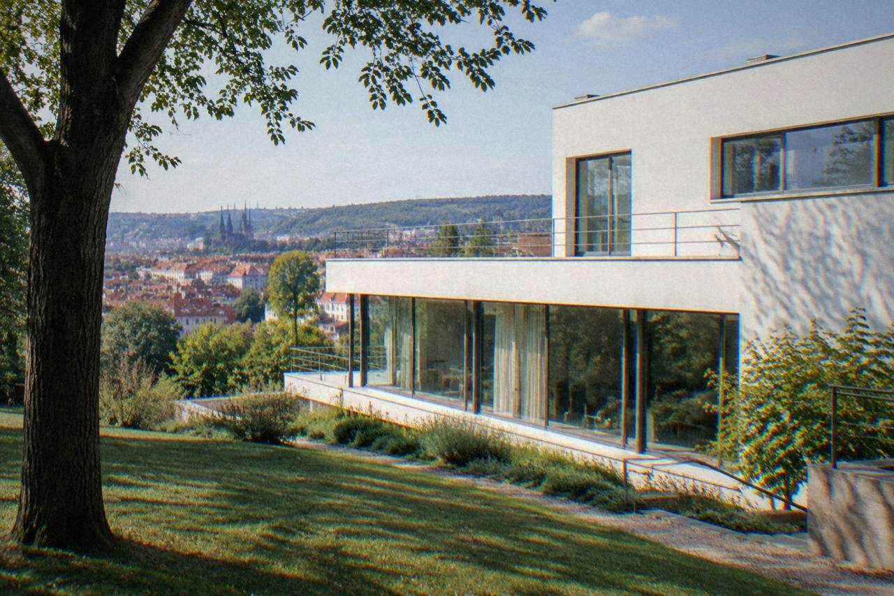 A white modernist villa with a flat roof and long horizontal windows set on a sloping garden