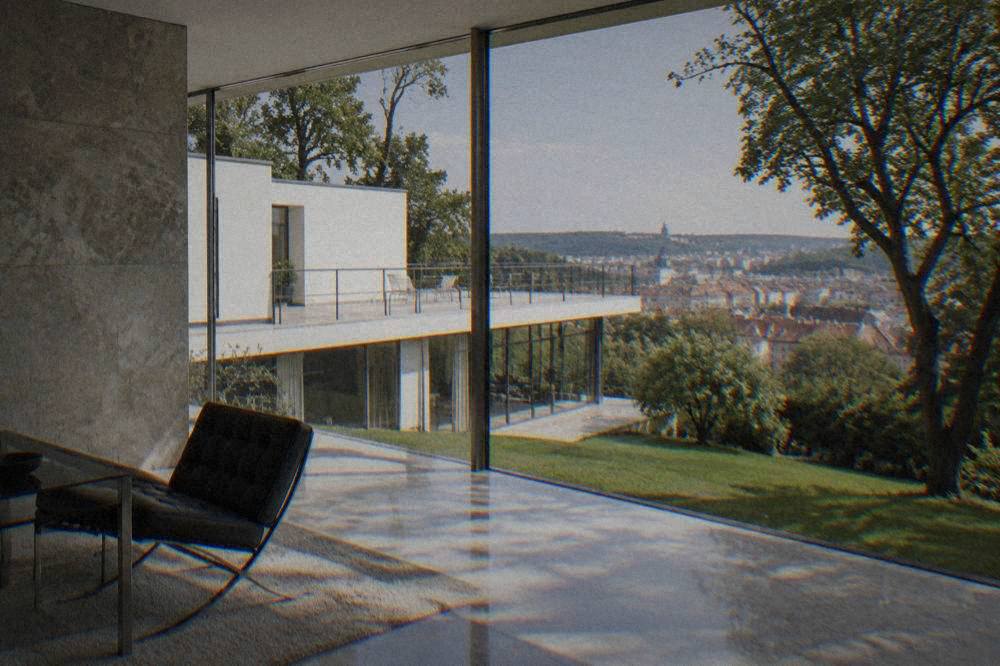A polished stone wall and floor-to-ceiling glazing inside a modernist house interior