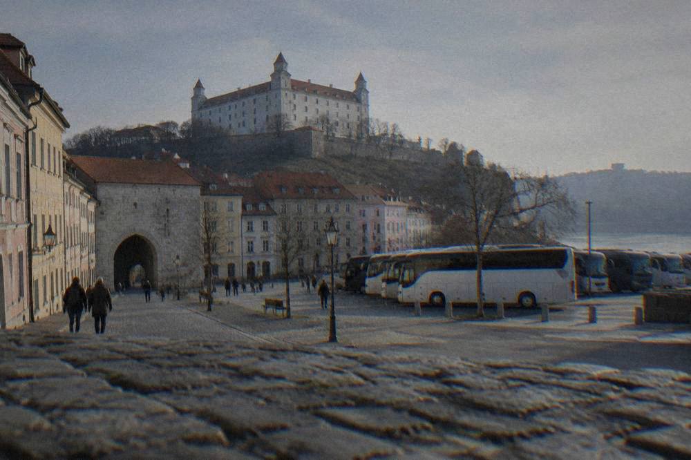 Long-distance coaches parked at a city bus terminal in daylight