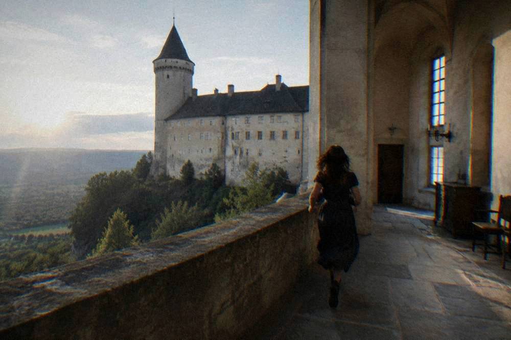A grand castle interior with period furnishings and tall windows