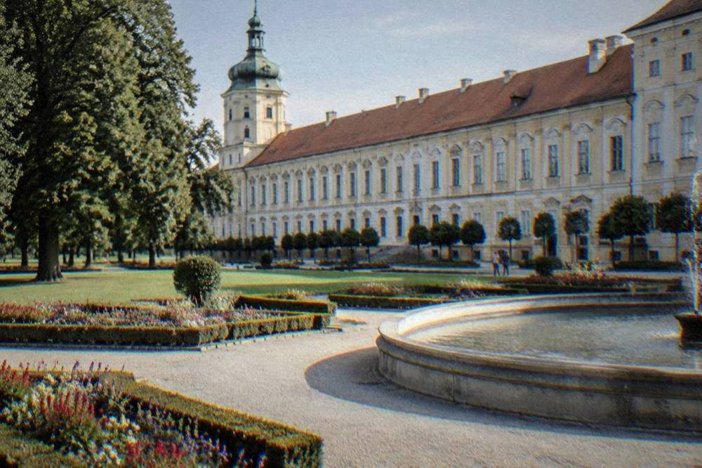 Ornamental garden parterre with flower beds and gravel paths leading to a fountain