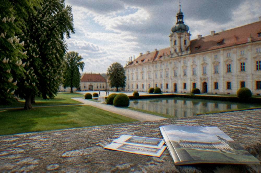 Tickets and a guidebook on a stone ledge overlooking a palace courtyard