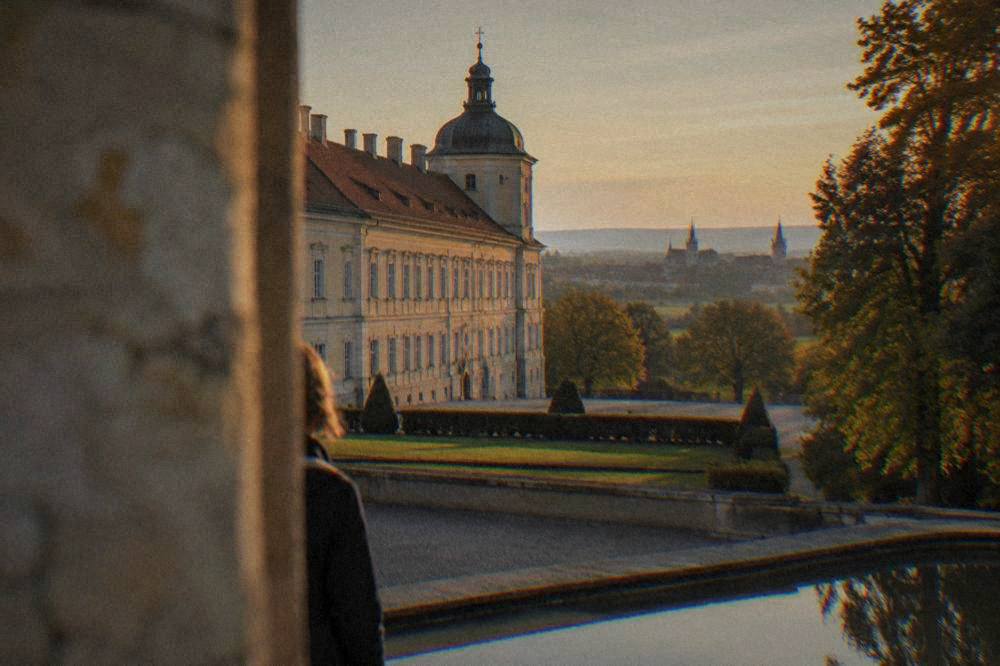 Two Moravian town skylines with church spires seen across open countryside