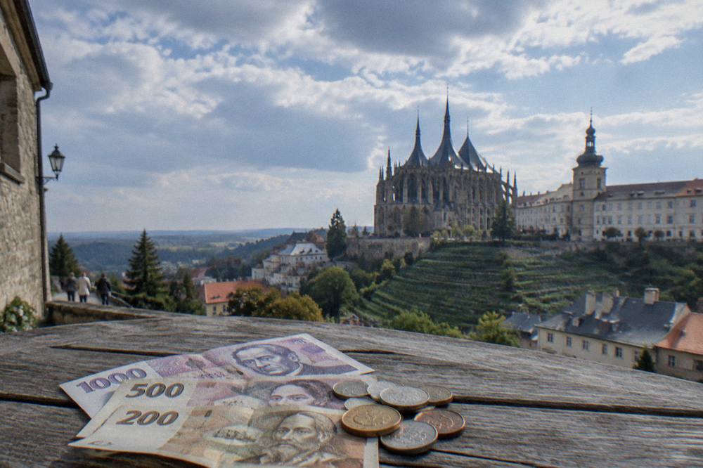Czech banknotes and coins of the koruna currency on a wooden table
