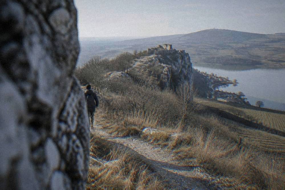 A footpath climbing through dry grassland toward the top of a limestone ridge