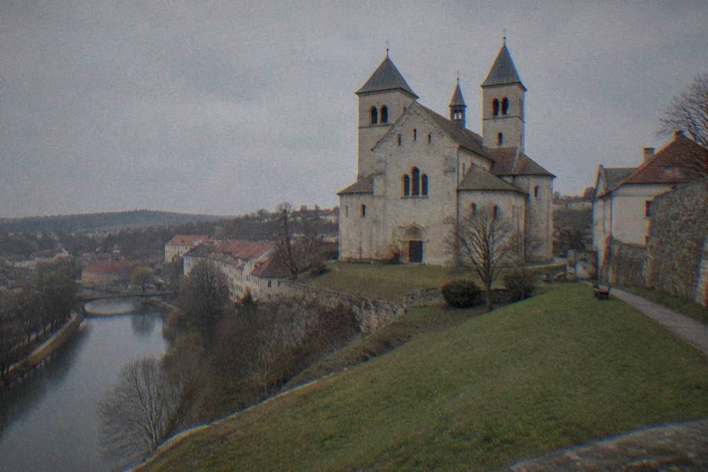 The west front of St Procopius Basilica in Třebíč seen from a lawn