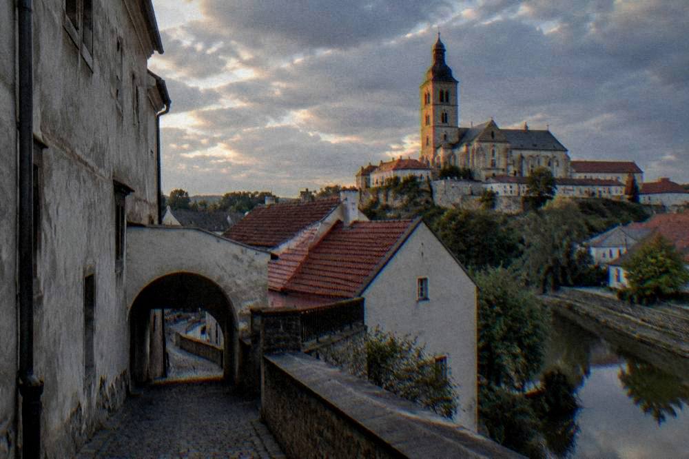 Evening light on the basilica tower seen across the rooftops of Třebíč