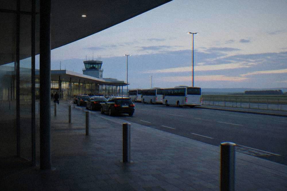 Taxi rank with several cars waiting beside a terminal building