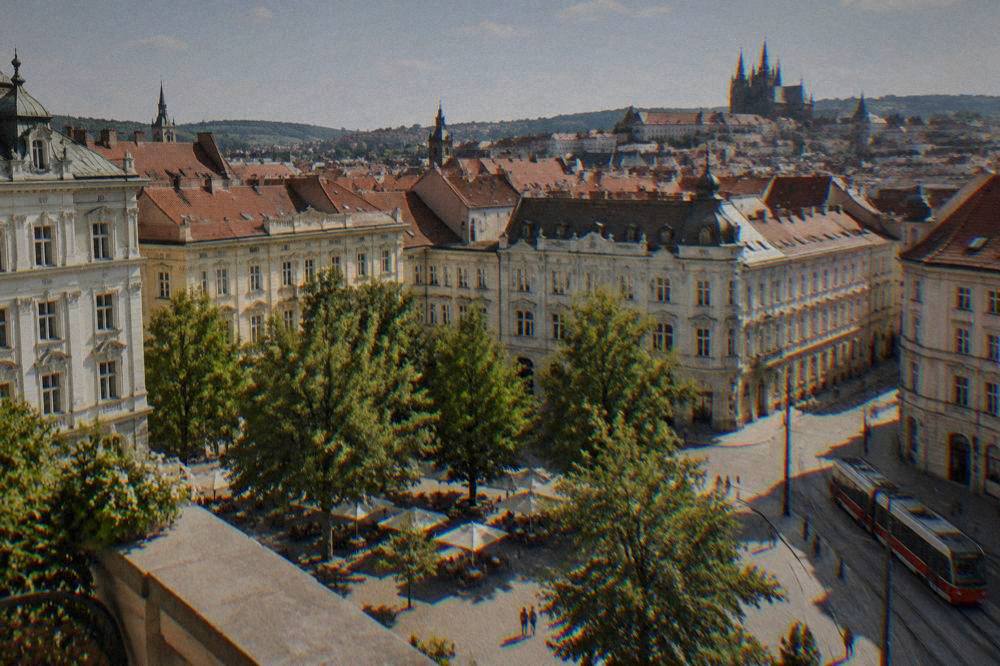 View over red rooftops and church spires from a city terrace