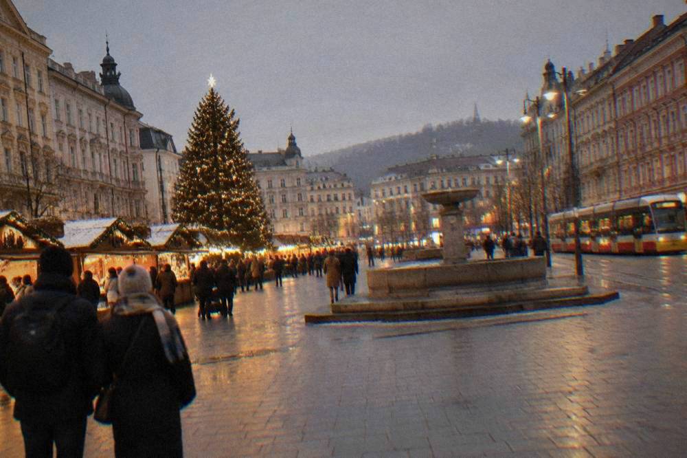 A decorated Christmas tree and market stalls in Freedom Square in Brno at night