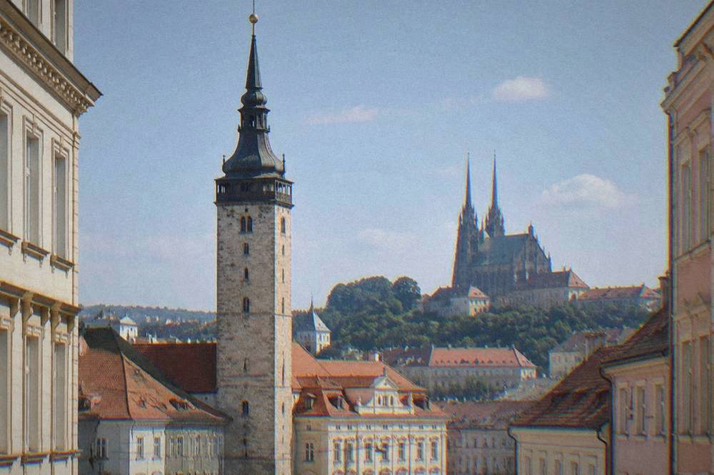 Close view of a bell tower against a blue sky in Brno