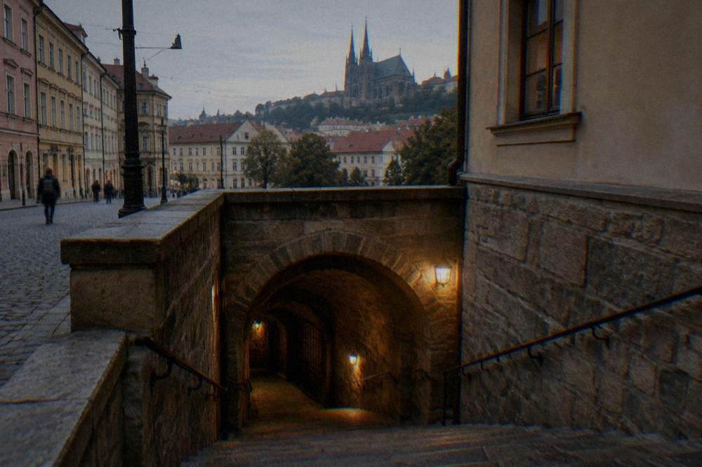 Stone staircase descending into an underground crypt in Brno