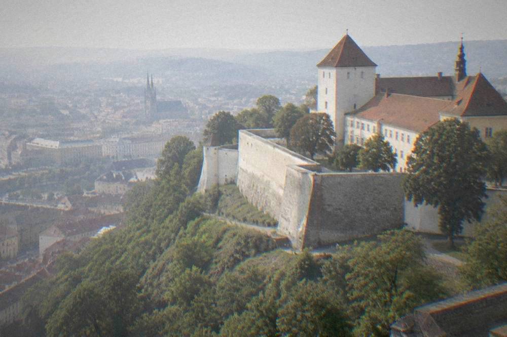 The thick fortress walls and towers of Špilberk Castle above the city of Brno