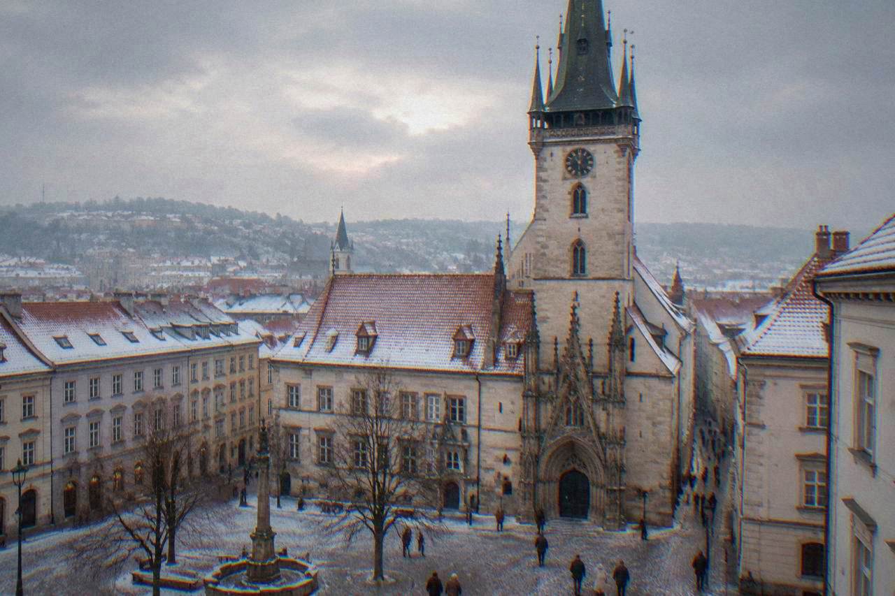 Brno's Old Town Hall tower and snow-dusted rooftops seen from the square below