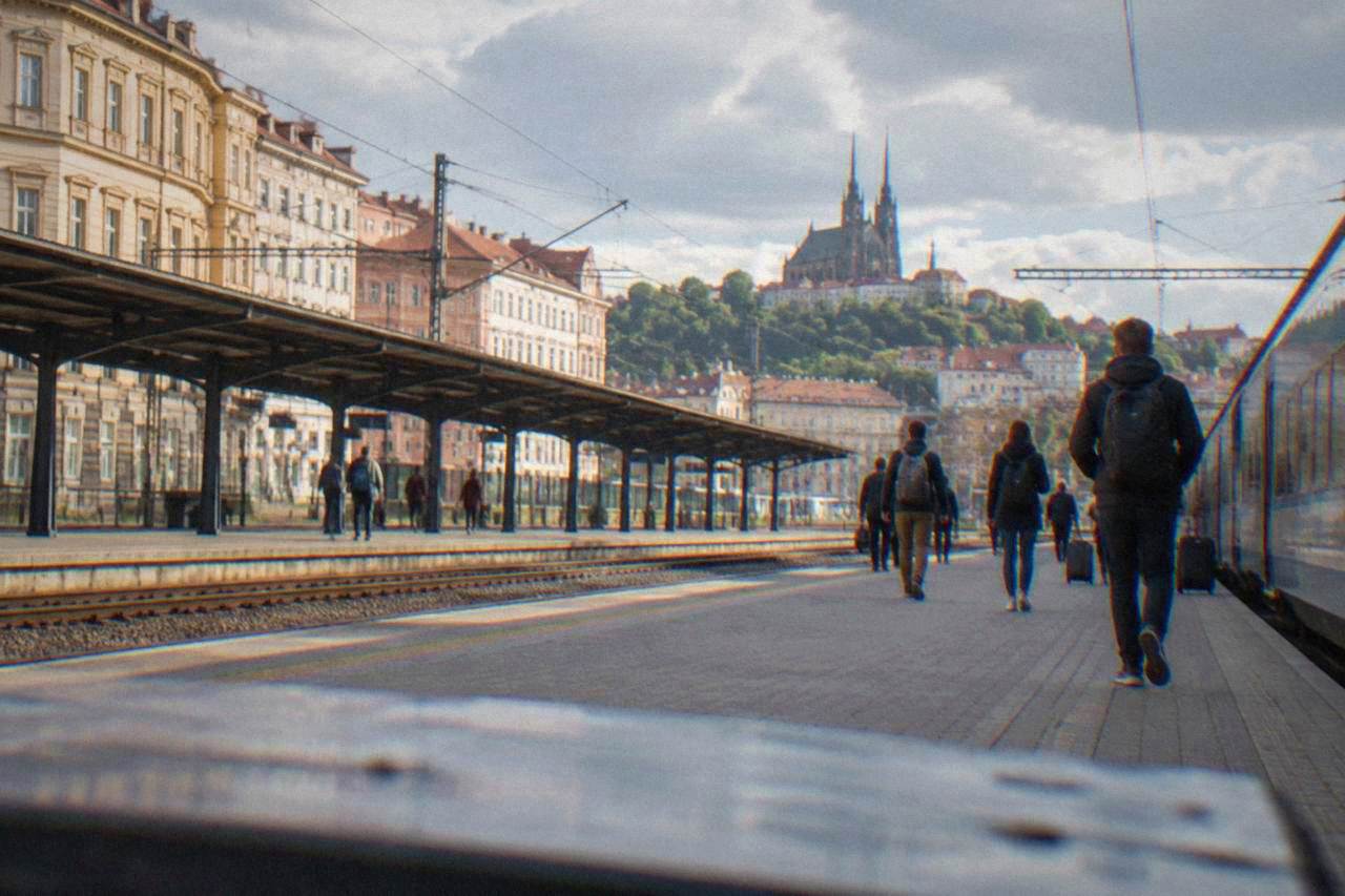 Train platforms at Brno main station with passengers carrying backpacks