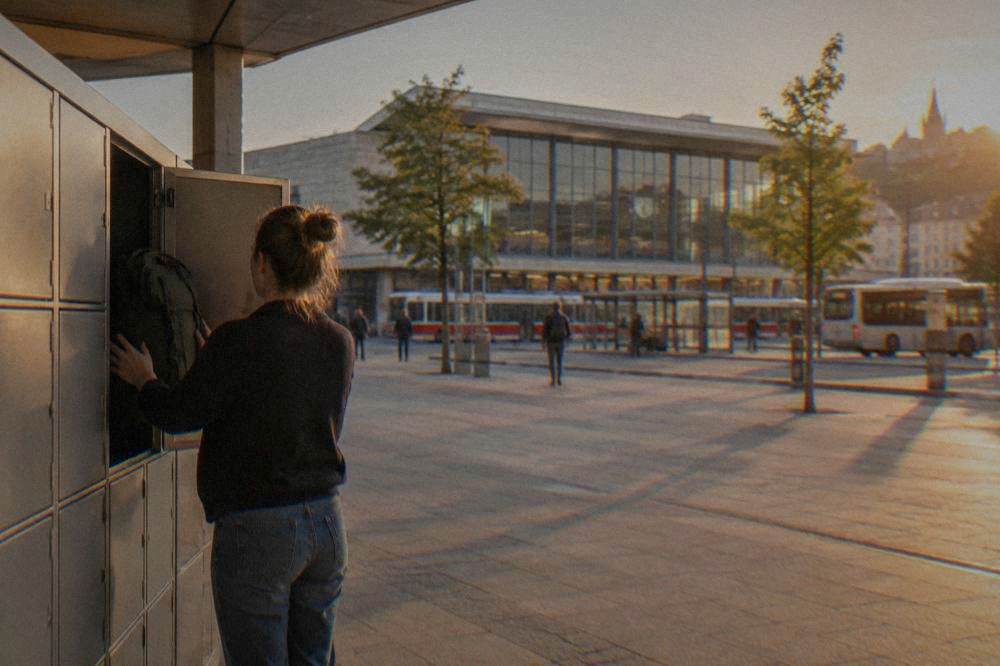 A traveller placing a backpack into a metal station locker