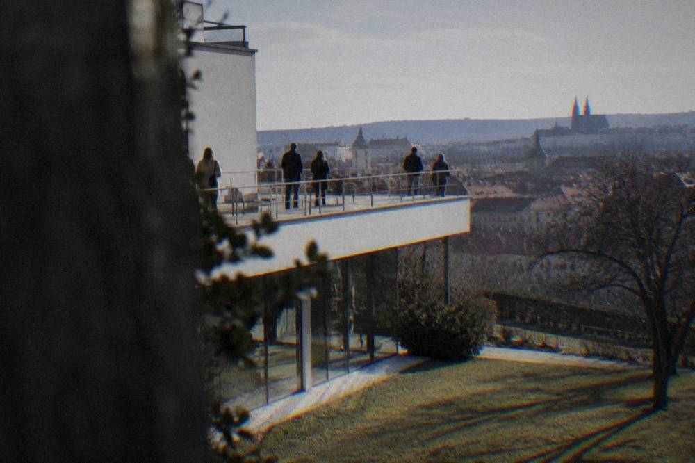 Visitors on the terrace of Villa Tugendhat with its garden and the city beyond