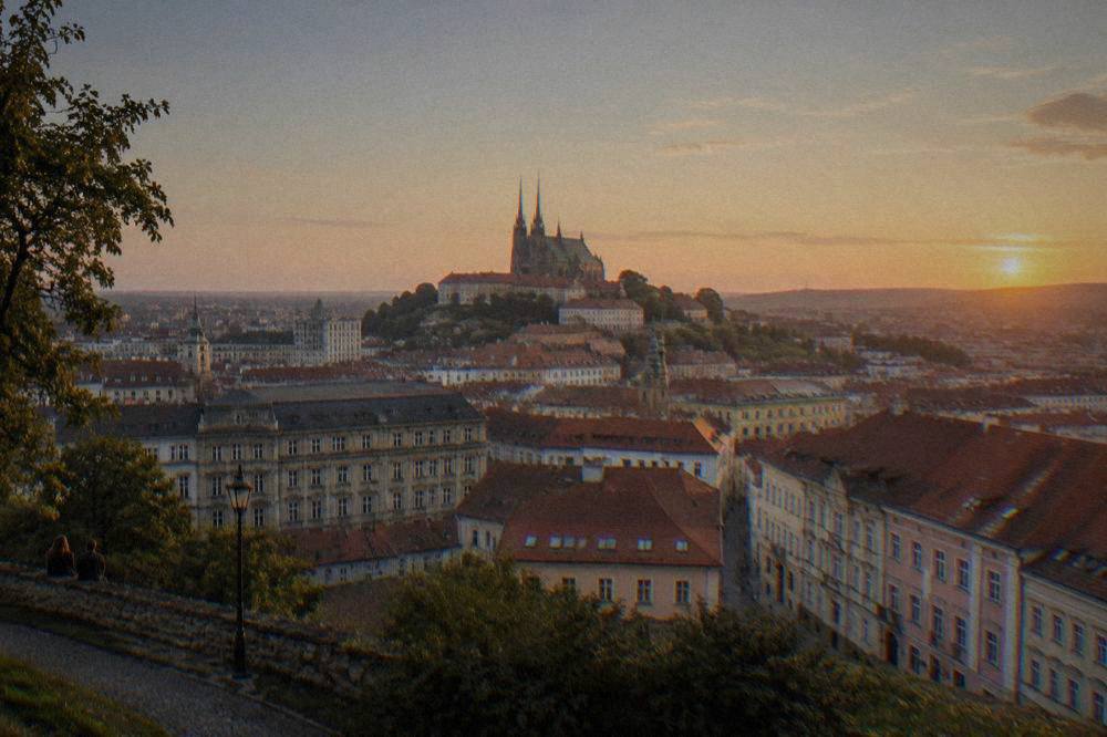 Evening view over the illuminated rooftops of central Brno from a hillside