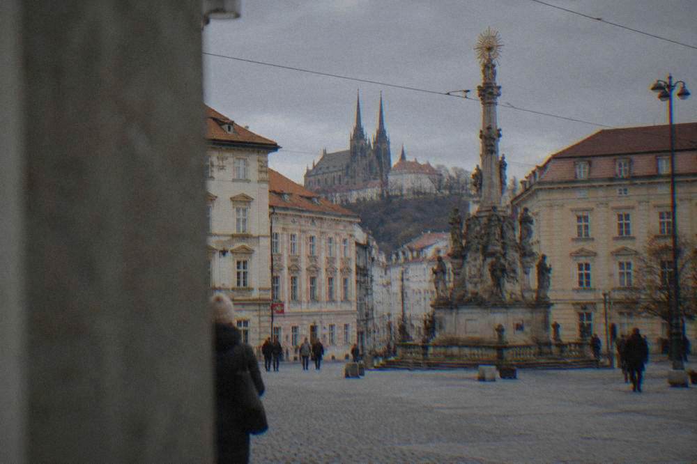 Historic buildings and the plague column on a Brno old-town square in daylight