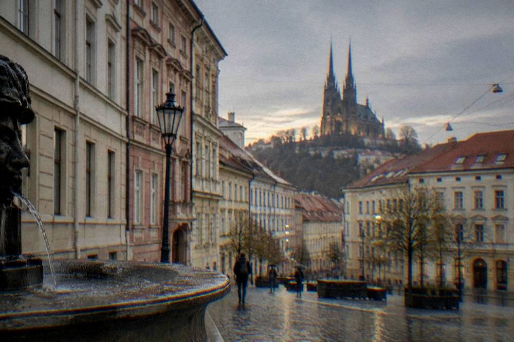 Gothic twin towers of the Brno cathedral against an evening sky