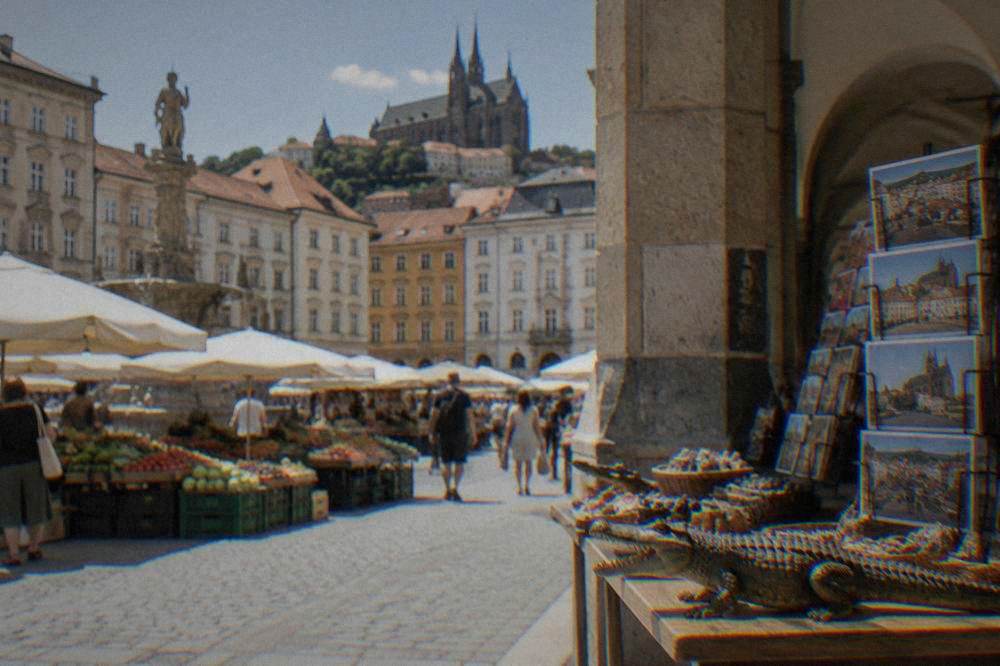 A crocodile-shaped souvenir and postcards on a market stall in a historic arcade