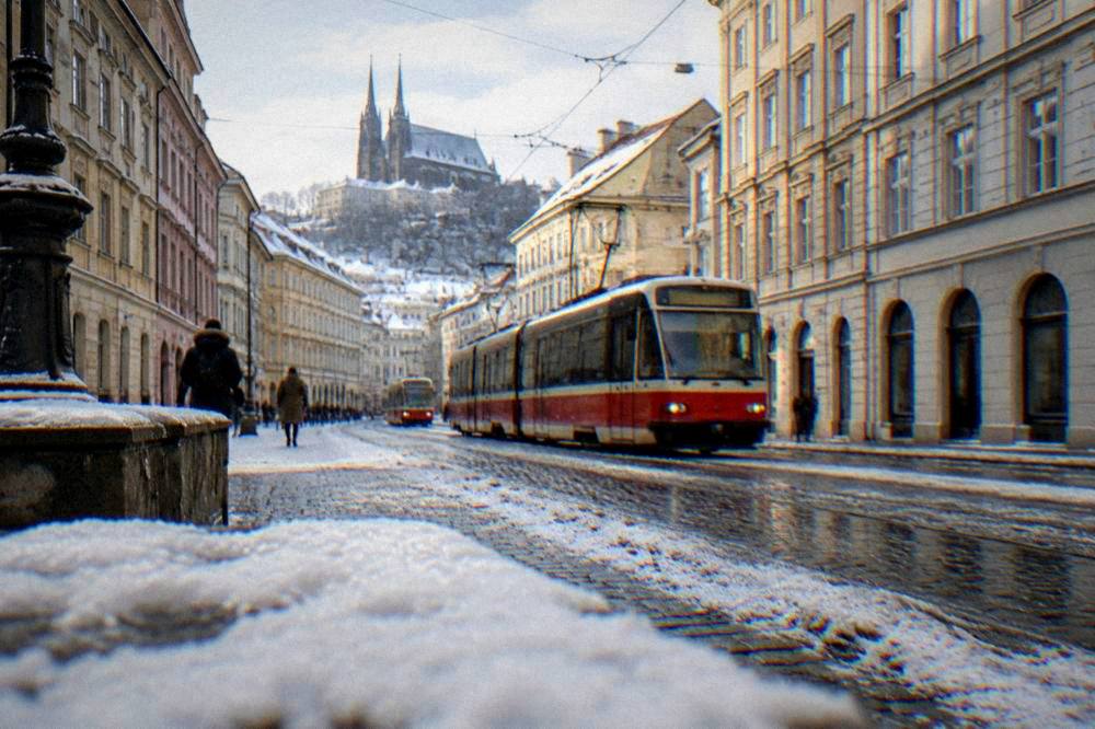 Snow lying on a Brno street with trams passing